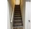 Staircase with carpet and wood railing leading up to the next level at 3323 E 36Th St, Indianapolis, IN 46218