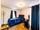 Bedroom featuring hardwood floors, a built-in headboard, and good light at 3420 N Chester Ave, Indianapolis, IN 46218