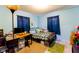 Bedroom with blue walls, a desk area, carpet, and natural light from the windows at 3420 N Chester Ave, Indianapolis, IN 46218