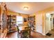 Dining room featuring hardwood floors, a wooden table with green chairs, and built-in shelving at 3420 N Chester Ave, Indianapolis, IN 46218