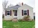 Charming home with vinyl siding, a brick chimney, and cute red shutters at 3420 N Chester Ave, Indianapolis, IN 46218