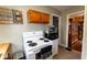 Cozy kitchen features white appliances, wall art, and cabinet storage at 3420 N Chester Ave, Indianapolis, IN 46218