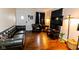 Living room with a dark leather sofa, hardwood floors, and a decorative cactus at 3420 N Chester Ave, Indianapolis, IN 46218