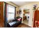 Sitting area with views into the kitchen and featuring a leather bench and hardwood floors at 3420 N Chester Ave, Indianapolis, IN 46218
