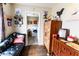 Sitting area with views into the kitchen and featuring a leather bench and hardwood floors at 3420 N Chester Ave, Indianapolis, IN 46218