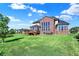 Beautiful brick home featuring a spacious backyard with a large deck and plenty of space to relax at 3715 Kendall Wood Dr, Carmel, IN 46032