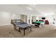 Finished basement with pool table, ping pong table, and seating for recreation and entertaining at 3715 Kendall Wood Dr, Carmel, IN 46032