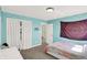 Bright bedroom with carpeting and a closet with white curtains, and bright turquoise walls at 3715 Kendall Wood Dr, Carmel, IN 46032