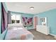 Cozy bedroom with a white bed, natural lighting, and bright turquoise walls at 3715 Kendall Wood Dr, Carmel, IN 46032