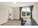 Bright bedroom boasts a large window with scenic views and stylish gray curtains at 3715 Kendall Wood Dr, Carmel, IN 46032