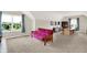 Spacious bonus room with bright natural light, plush carpet, and comfortable futon seating at 3715 Kendall Wood Dr, Carmel, IN 46032