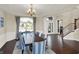 Formal dining room with hardwood floors, large arched window, and stylish decor at 3715 Kendall Wood Dr, Carmel, IN 46032