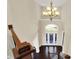 Open, two-story foyer with a grand chandelier and lots of natural light at 3715 Kendall Wood Dr, Carmel, IN 46032