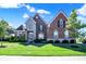 Charming two-story home with a well-manicured lawn and inviting front entrance at 3715 Kendall Wood Dr, Carmel, IN 46032