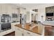 Modern kitchen with stainless steel appliances, granite countertops, and views to living area at 3715 Kendall Wood Dr, Carmel, IN 46032