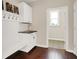 Well-organized mudroom with a bench, coat hooks, and storage cabinets for convenient entry at 3715 Kendall Wood Dr, Carmel, IN 46032