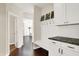 Hallway with coat hooks, bench, storage cabinets, and granite countertop at 3715 Kendall Wood Dr, Carmel, IN 46032