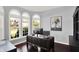 Bright office with dark wood floors, dark desk, three arched windows, and gray walls at 3715 Kendall Wood Dr, Carmel, IN 46032