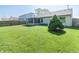 Wide view of back of house with a sprawling green lawn and privacy fence at 377 Van Buren St, Greenfield, IN 46140