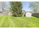 Spacious backyard featuring well-maintained lawn and storage shed at 377 Van Buren St, Greenfield, IN 46140