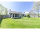 Expansive backyard with well-kept lawn, featuring a screened-in porch at 377 Van Buren St, Greenfield, IN 46140