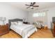 Bright bedroom with hardwood floors, ceiling fan, and a comfortable sitting area at 377 Van Buren St, Greenfield, IN 46140