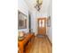 Inviting entryway with light wood floors, light colored walls, and console table with decor at 377 Van Buren St, Greenfield, IN 46140