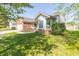 Well-maintained single Gathering home featuring a brick facade, attached garage, and well-maintained front lawn at 377 Van Buren St, Greenfield, IN 46140