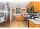 Bright kitchen featuring stainless steel appliances, wood cabinets, and stone backsplash at 377 Van Buren St, Greenfield, IN 46140