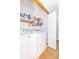 Well-lit laundry room with washer and dryer and ample shelf space at 377 Van Buren St, Greenfield, IN 46140