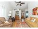 Spacious living room with lots of seating, neutral walls, wood-look floors, and a ceiling fan at 377 Van Buren St, Greenfield, IN 46140
