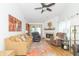 Bright living room featuring vaulted ceilings, neutral walls, a fireplace, and comfortable seating at 377 Van Buren St, Greenfield, IN 46140