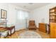Comfortable office space with hardwood floors, area rug, a cozy chair, and built in shelving at 377 Van Buren St, Greenfield, IN 46140