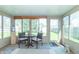 Bright sunroom with large windows and seating area at 377 Van Buren St, Greenfield, IN 46140