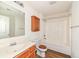 Bathroom featuring a vanity, toilet, and shower-tub combination with wooden accents at 3818 Gray Pond Ct, Indianapolis, IN 46237