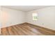 Cozy bedroom showcasing wood flooring and a window with a serene view at 3818 Gray Pond Ct, Indianapolis, IN 46237