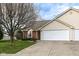 Inviting home featuring a two-car garage, neutral siding, manicured lawn, and mature trees at 3818 Gray Pond Ct, Indianapolis, IN 46237