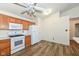 Spacious kitchen features wood cabinets, white appliances, and laminate floors at 3818 Gray Pond Ct, Indianapolis, IN 46237