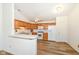 Kitchen boasts wood cabinets, white appliances, laminate floors and a breakfast bar at 3818 Gray Pond Ct, Indianapolis, IN 46237