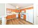 Kitchen boasts wood cabinets, white appliances, laminate floors and a ceiling fan at 3818 Gray Pond Ct, Indianapolis, IN 46237