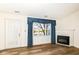Bright living room featuring laminate floors, fireplace, large windows and backyard pond view at 3818 Gray Pond Ct, Indianapolis, IN 46237