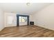 Bright living room featuring laminate floors, fireplace and large windows providing natural light at 3818 Gray Pond Ct, Indianapolis, IN 46237