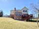 The backyard of this two-story home has a wood deck and brick chimney at 3926 Castle Rock Dr, Zionsville, IN 46077