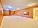 Spacious finished basement with recessed lighting and neutral carpet, providing a blank canvas for your personalized design at 3926 Castle Rock Dr, Zionsville, IN 46077