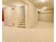 Spacious basement with neutral carpet, bright lighting, and staircase at 3926 Castle Rock Dr, Zionsville, IN 46077