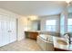 Bathroom featuring tile floor, soaking tub, double vanities, large mirrors, and a separate walk-in shower at 3926 Castle Rock Dr, Zionsville, IN 46077