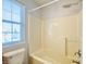 Bright bathroom featuring a window next to the tub-shower, providing natural light and ventilation to the space at 3926 Castle Rock Dr, Zionsville, IN 46077