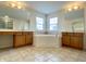 Bathroom with a soaking tub, double vanities, large mirrors, tile floor, and a walk-in shower in view at 3926 Castle Rock Dr, Zionsville, IN 46077