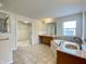 Bathroom featuring tile floor, soaking tub, double vanities, large mirrors, and a walk-in shower in view at 3926 Castle Rock Dr, Zionsville, IN 46077