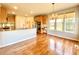Open kitchen with hardwood floors, granite counters and dining area with backyard view at 3926 Castle Rock Dr, Zionsville, IN 46077